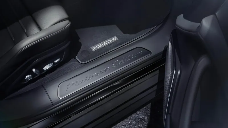 Porsche Panamera Platinum Edition door sill plate with 'Panamera Platinum Edition' text, inside luxury car cabin