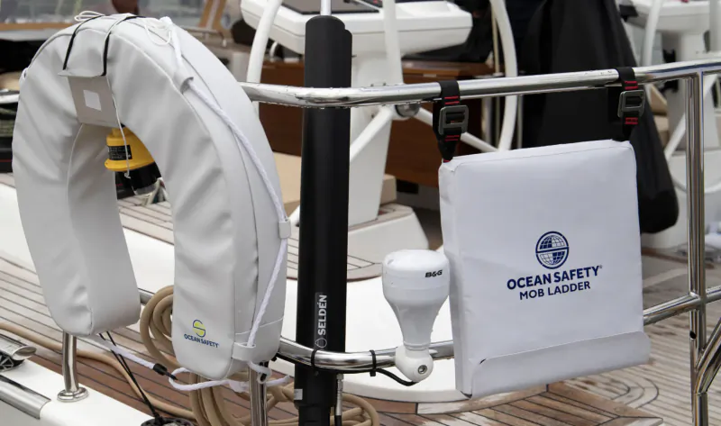 White Ocean Safety MOB ladder lifebuoy and boarding ladder mounted on yacht railing