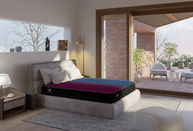 Modern bedroom with Eight Sleep Pod mattress in purple-black, open doors to brick balcony at sunset.