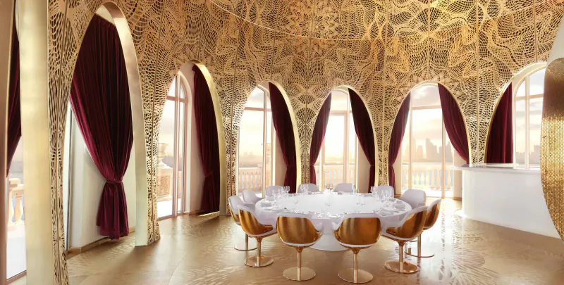 Elegant Raffles The Palm Dubai dining room with gold-domed arches, burgundy curtains, round white table, and gold chairs.