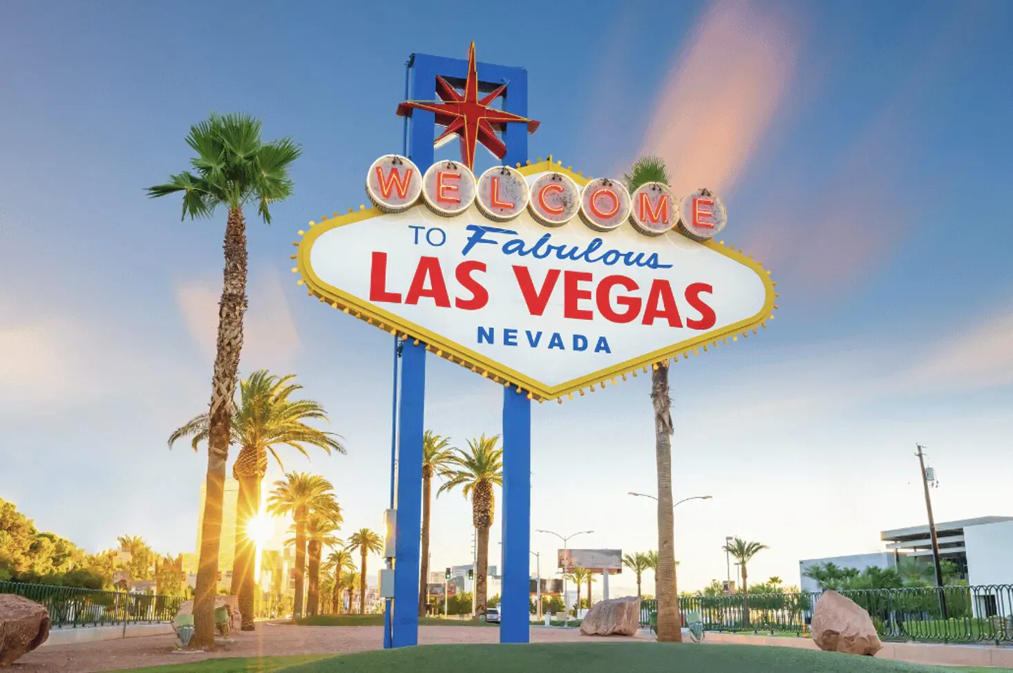 Iconic 'Welcome to Fabulous Las Vegas Nevada' sign with palm trees at sunset.