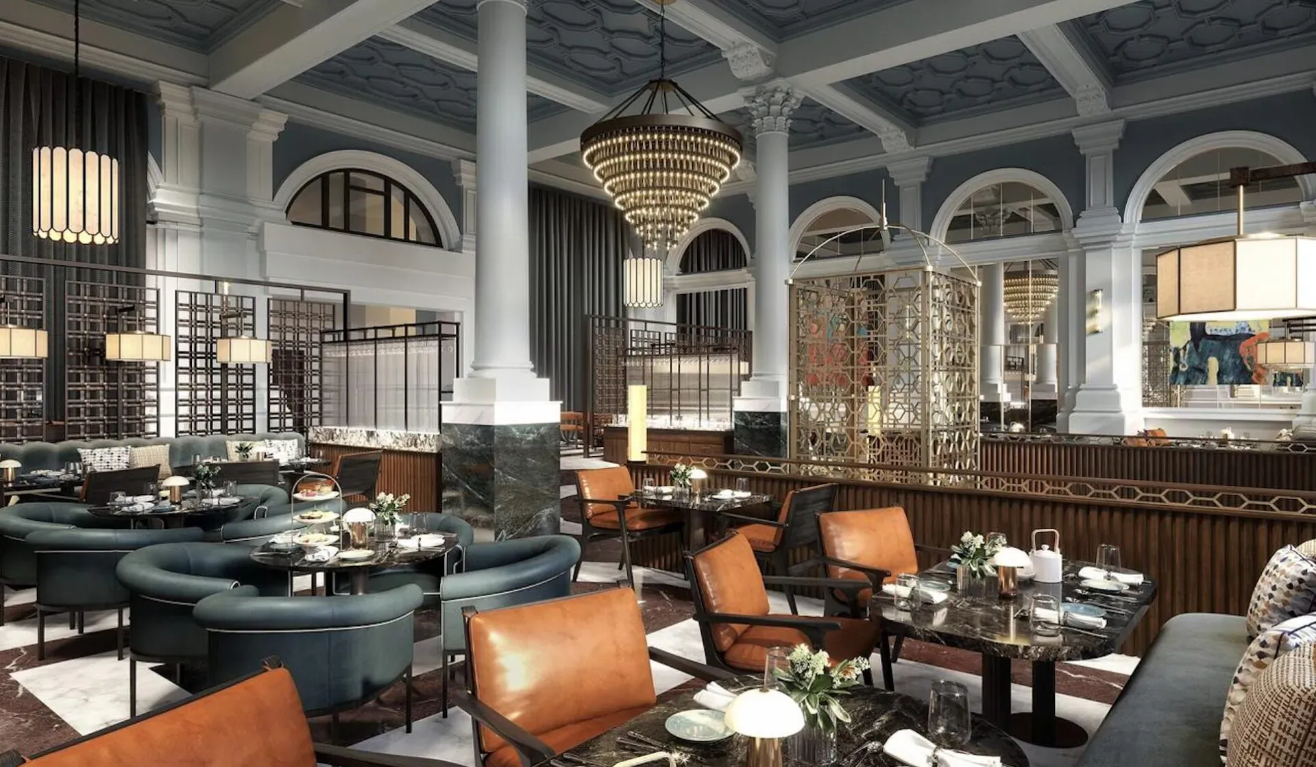 Elegant dining room at The Parkgate Hotel Cardiff with ornate chandelier, teal and orange chairs, and wooden bar.