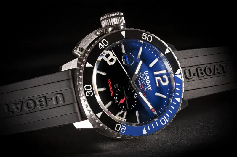 U-Boat Sommerso 46mm dive watch with blue dial, black rubber strap, and red accents on black background