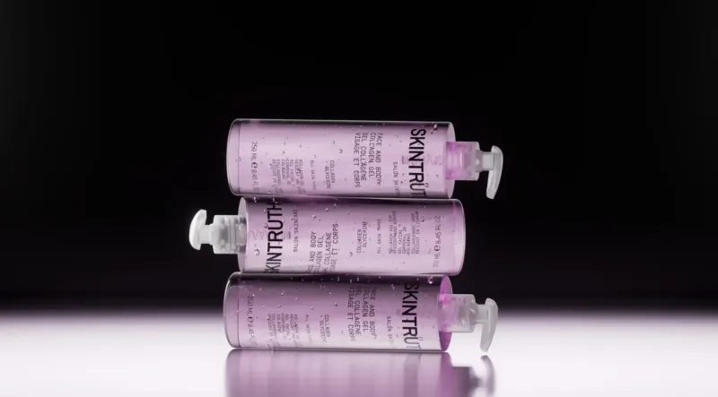 Three stacked pink Beautyntri moisturizer bottles with pump dispensers on reflective surface.
