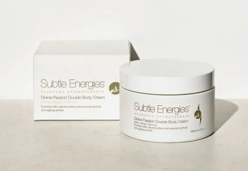Subtle Energies Divine Passion Dual Body Cream in white box and jar on light surface.