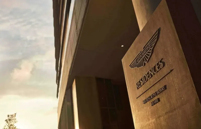 Aston Martin Residences sign on modern Miami building exterior at dusk
