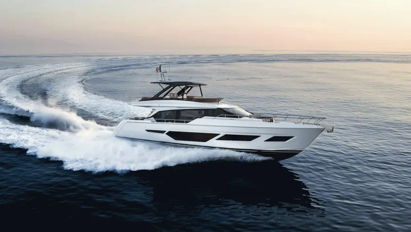 White Ferretti Yachts 720 speeding across ocean at sunset, creating white wake trails.