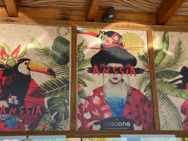 Tropical gastrobeach poster of woman in red kimono with toucans, palms; 'ANYSsia' and 'Asscona' text under thatched roof