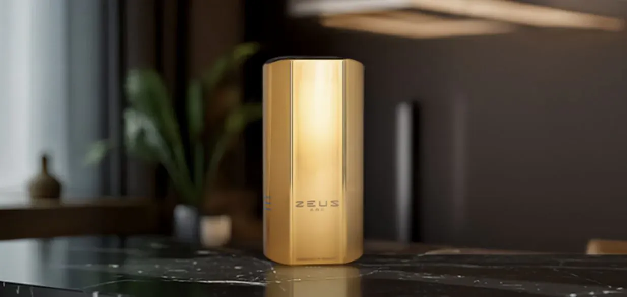 Gold PULS vaporizer on marble table in modern room with plants, 'PULS' logo visible.