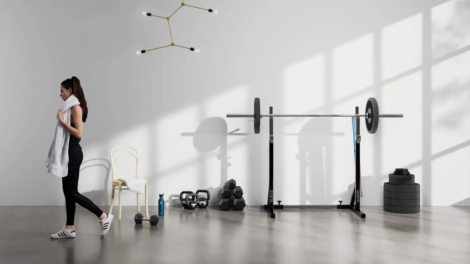 Woman holding white towel stands by Eleiko barbell rack with weights and gold constellation light fixture