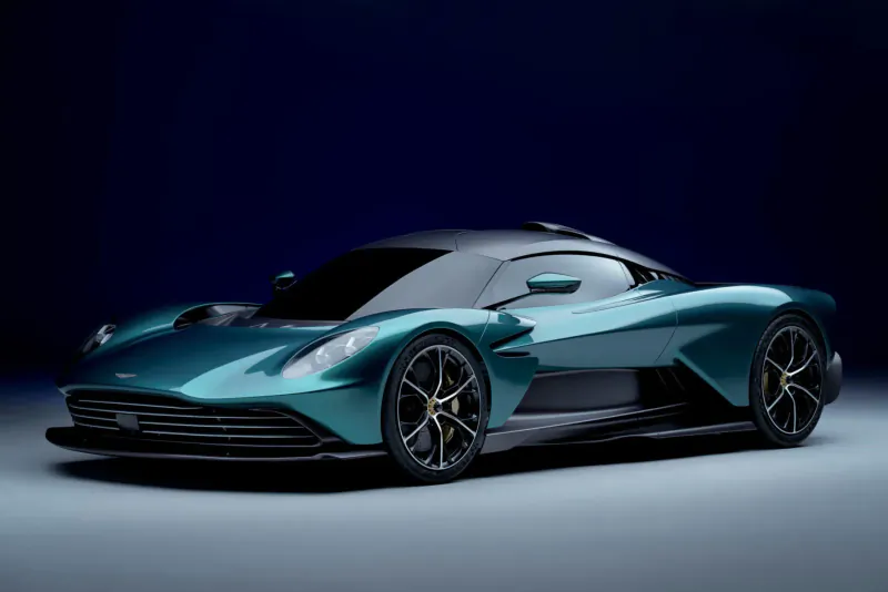Aston Martin Valhalla hybrid supercar in teal, sleek angular design, black accents, on dark blue background