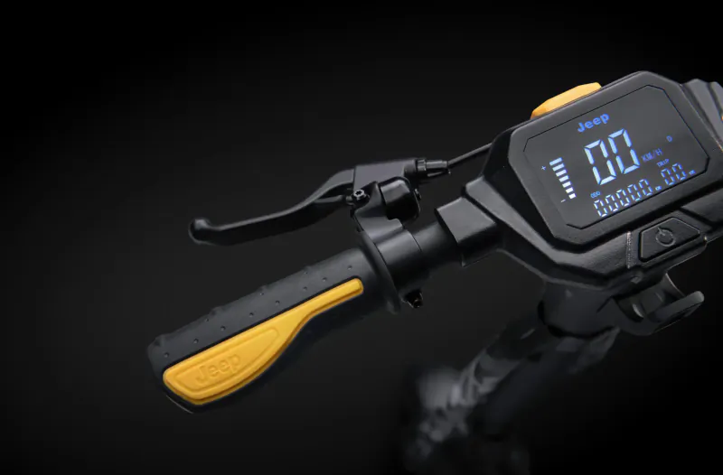 Close-up of Jeep Urban e-scooter handlebar with yellow grips and digital display showing metrics.