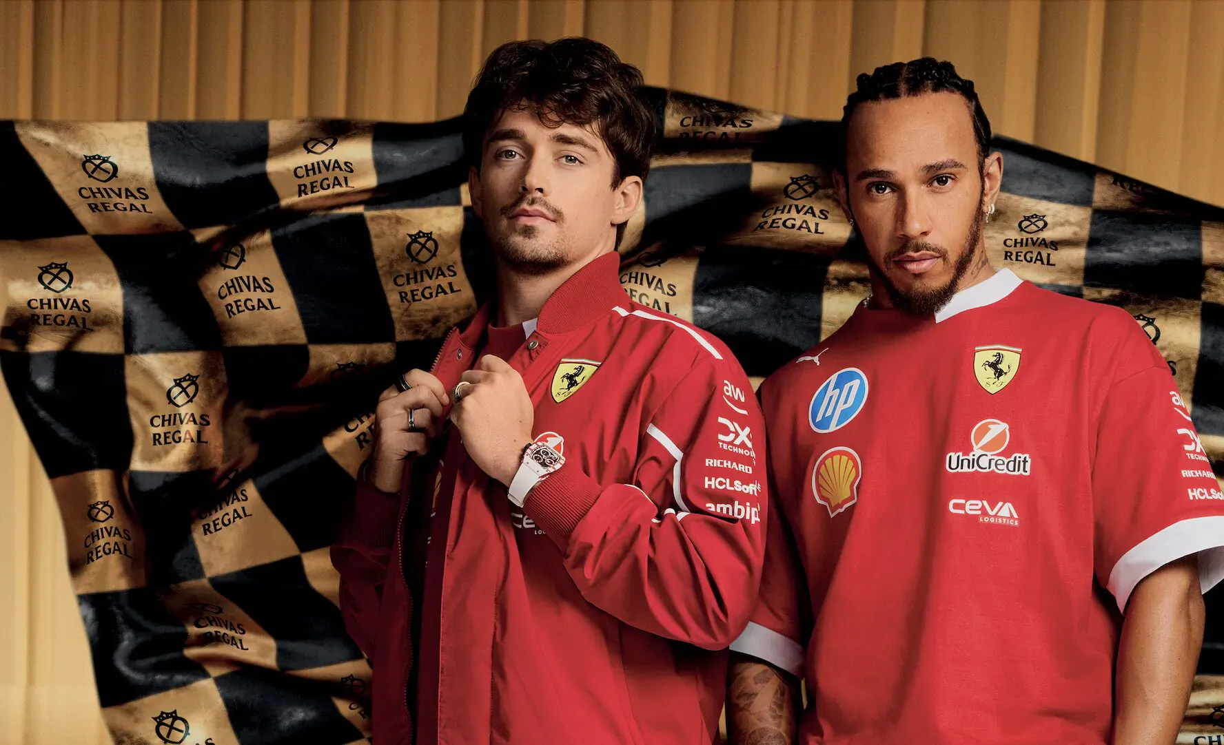 Charles Leclerc and Lewis Hamilton in Ferrari red shirts with sponsor logos, against Chivas Regal gold-black backdrop.