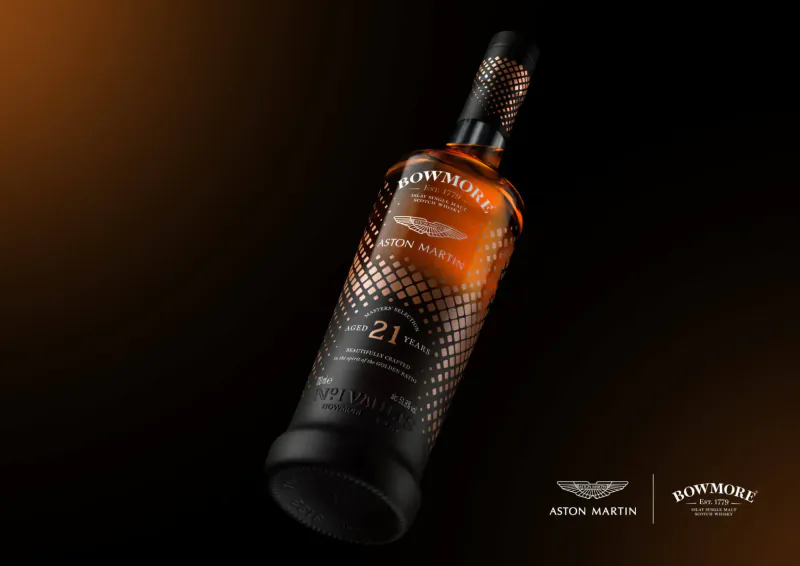Bowmore 21 Year Old whisky bottle in Aston Martin Bowmore Masters' Selection collaboration, angled on dark gradient background
