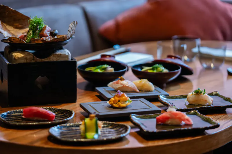 Assortment of elegant sushi and sashimi on a wooden table at UMU restaurant, Mayfair.