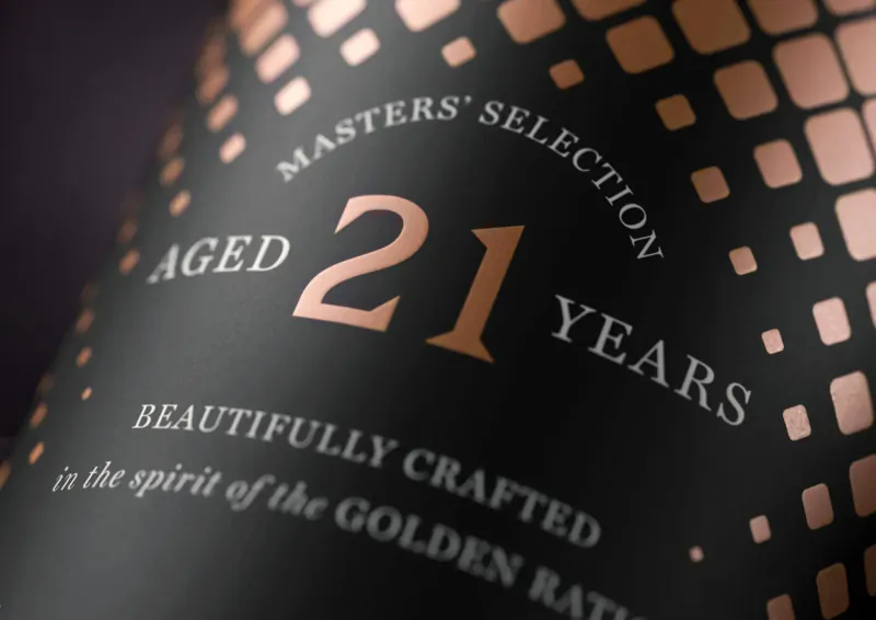 Close-up of Bowmore Masters' Selection 21 Years Aged whisky bottle label, 'Beautifully crafted in the spirit of the Golden Ratio'.