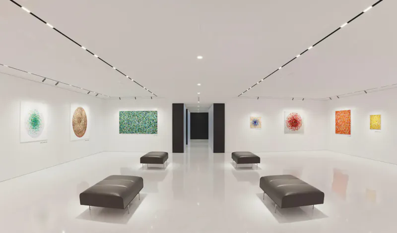 Aston Martin Residences art gallery showcasing Robi Walters' abstract paintings on white walls with black benches