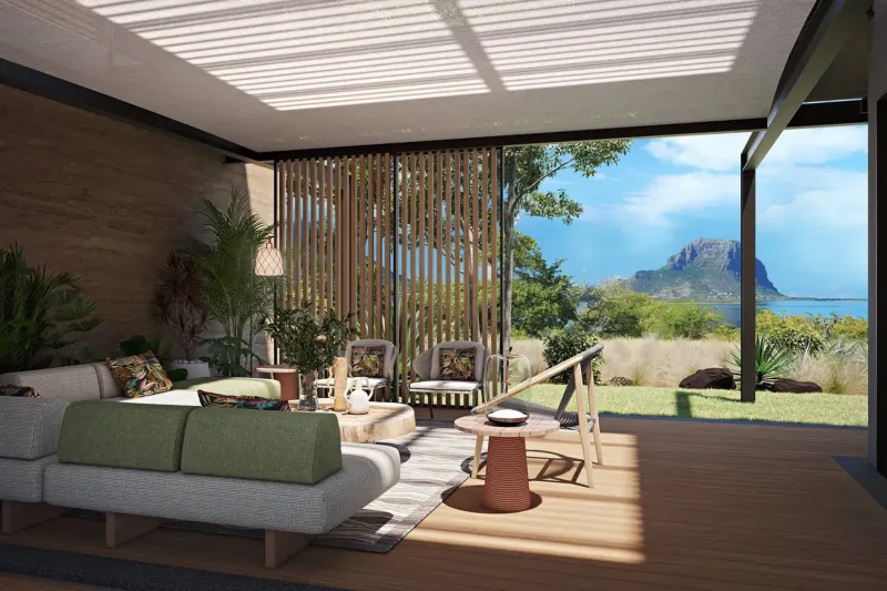 Modern Mauritian living room with wooden accents, plush seating, plants, and panoramic view of mountain and ocean.