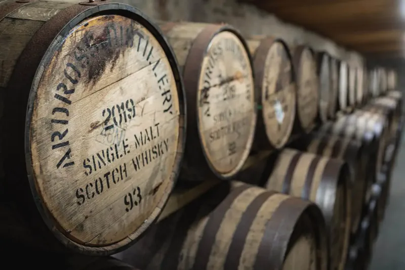 Ardross Distillery 2019 single malt Scotch whisky barrels stacked in a warehouse.