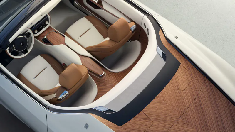 Rolls-Royce Arcadia Droptail interior: white leather seats, tan headrests, wood floor, overhead view