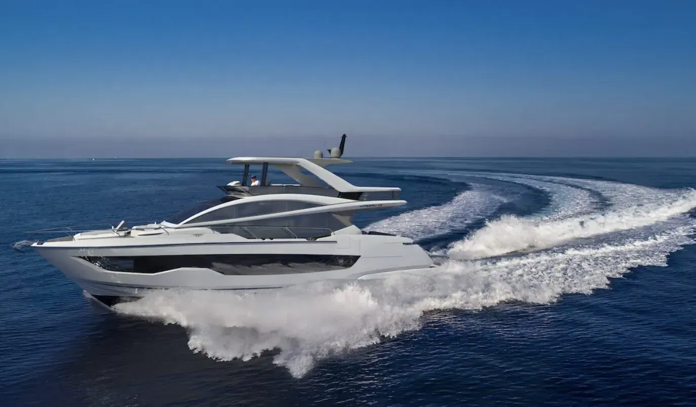 White Pearl 63 yacht speeding on blue sea, creating white wake trails, sleek multi-deck design.