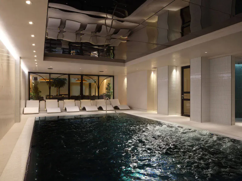 Elegant indoor pool at The Other House with white loungers, mirrored ceiling, and plants.