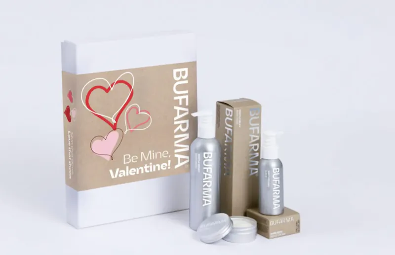Bufarama luxury skincare Valentine's Day gift set: 'Be Mine' box, pump bottle, lotion, spray bottle, and soap on beige background.