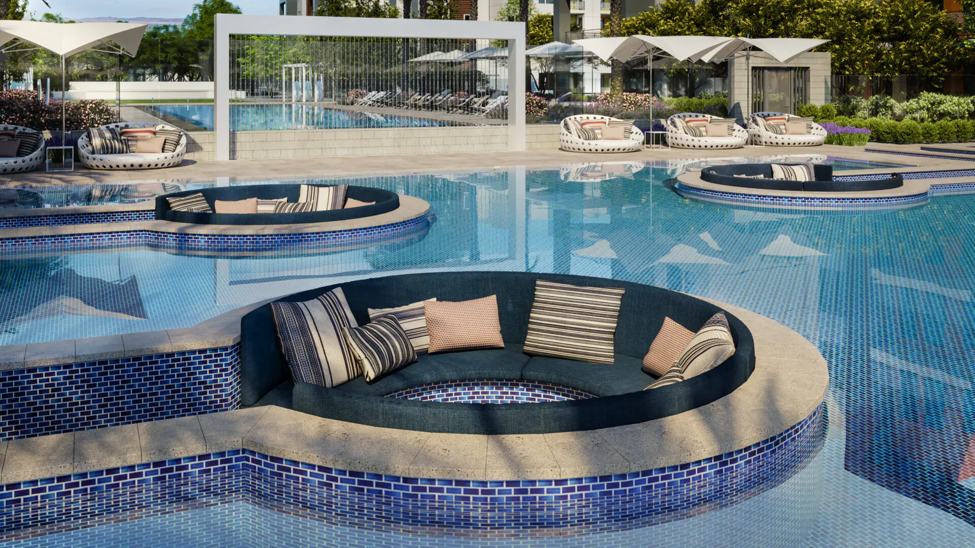 Modern cushioned seating area in turquoise infinity pool at Ariva Serviced Residences resort, Las Vegas.