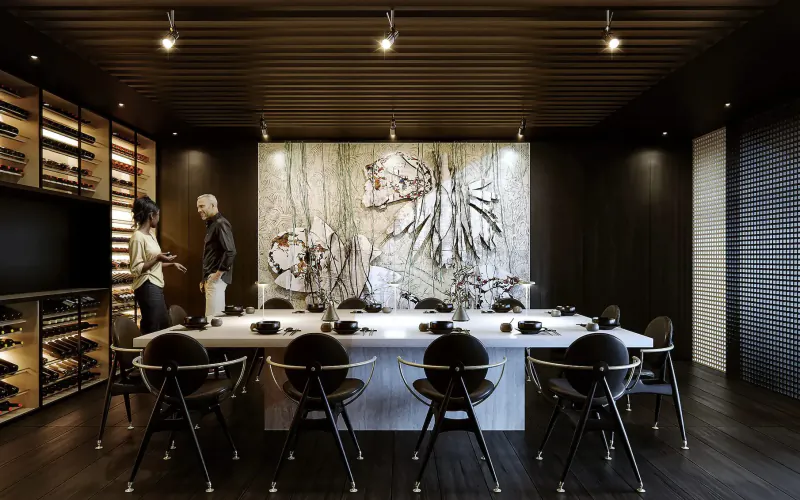 Modern dining room in art'otel Rome with abstract wall art, wine racks, long white table set for meal, two people standing nearby.