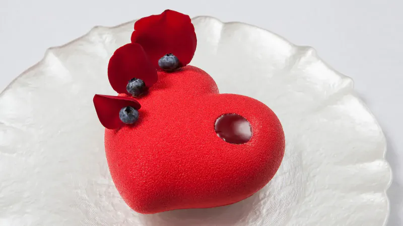 Heart-shaped red velvet cake topped with rose petals and blueberries on white plate, Love by Four Seasons Hotel Bengaluru