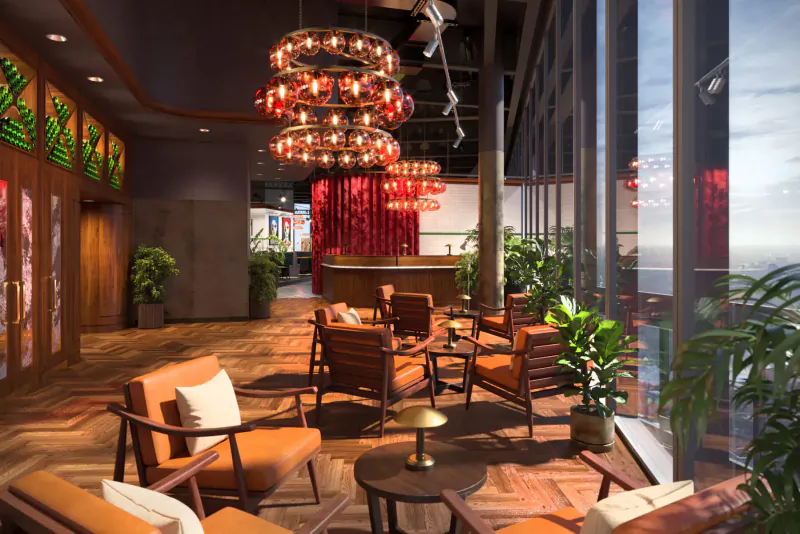 Luxurious modern lounge with red chandelier, orange chairs, plants, red curtains, and ocean view windows.