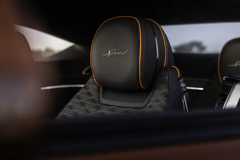 Bentley Continental GT Speed rear headrests with orange 'Bentley' logo and stitching, interior view