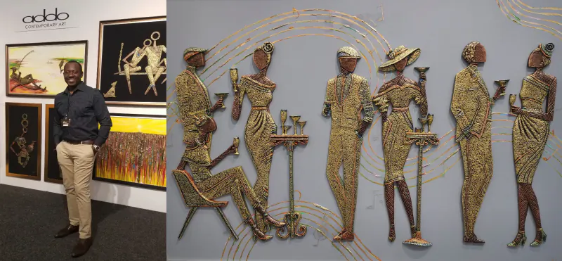 Man in blue shirt stands beside gold sculptures of stylish Black women holding drinks at ADDO Gallery exhibit.