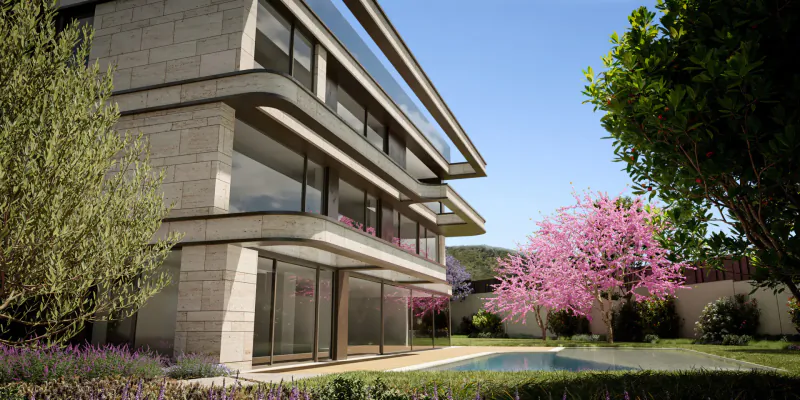 Modern ultra-luxury villa in Barcelona with stone facade, large glass windows, pool, and pink cherry trees