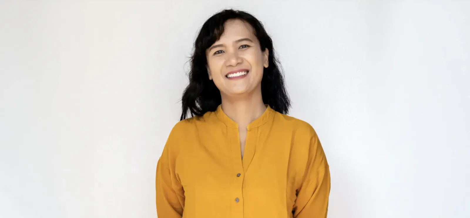 Maya Etika Alwi, GM of Cocana Resort, smiling in yellow collared blouse