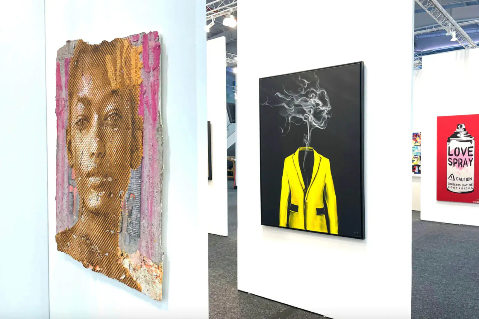 ArtExpo Dallas: Portrait of Black woman in pink frame, yellow jacket figure smoking on black, 'LOVE SPRAY' Banksy-style can in red.