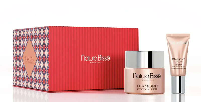 Natura Bissé Diamond Serum box and tube on red patterned gift box, luxury skincare set.