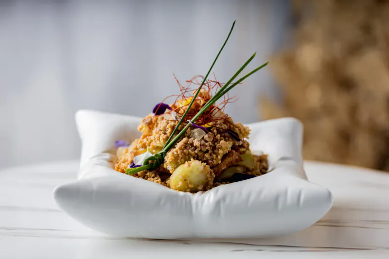 Blue Jasmine: refined Southeast Asian rice dish with grains, sprouts, chilies, and garnishes in white bowl