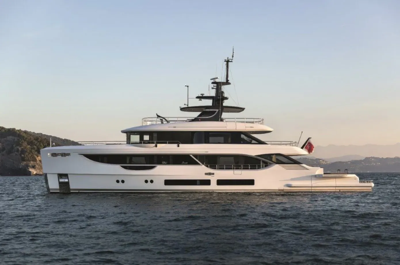 White Benetti Oasis 34m luxury superyacht with Turkish flag anchored in calm bay at sunset, hills backdrop.