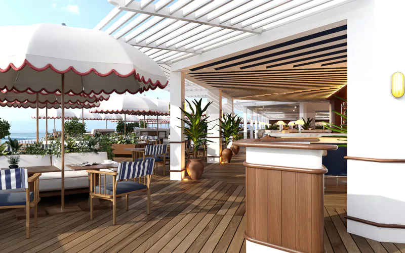 Luxurious outdoor terrace at Ciro’s, Hôtel Barrière Le Majestic Cannes, with white umbrellas, striped chairs, wooden bar, plants, and ocean view.