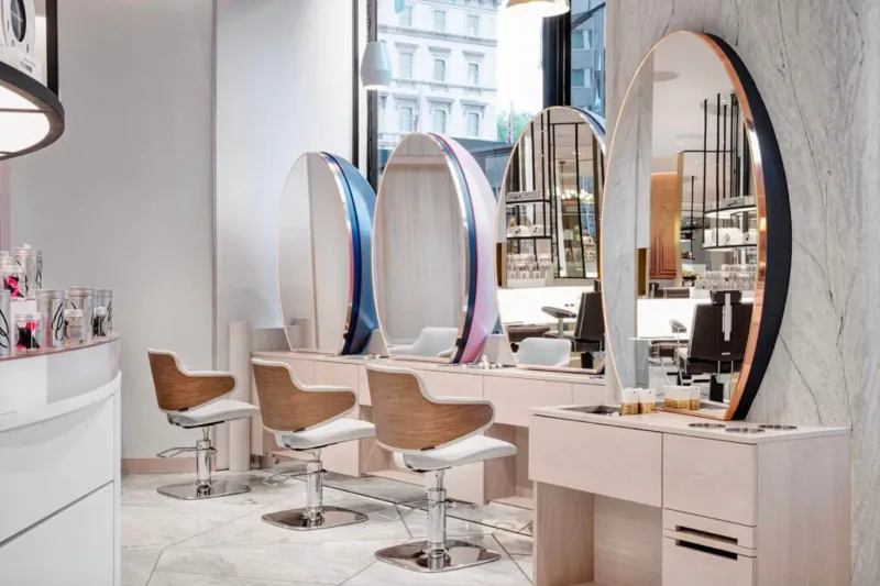Modern Jo Hansford hair salon interior with colorful oval mirrors, swivel chairs, and reception desk