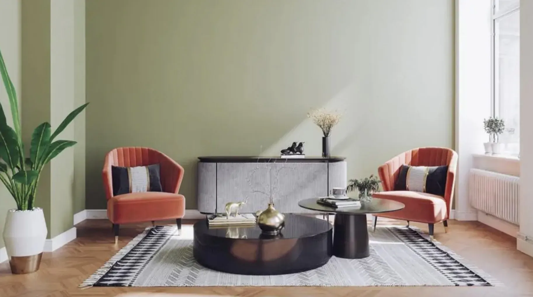Modern living room with two orange velvet armchairs, black round coffee table on gray rug, green walls, plants