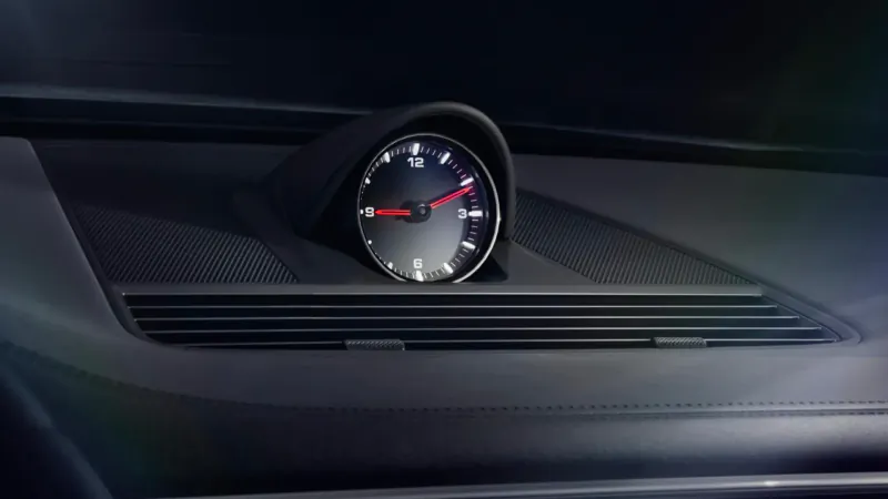 Close-up of black analog clock with red hands on Panamera Platinum Edition dashboard