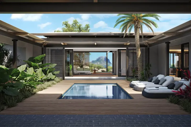 Modern Mauritian villa courtyard with infinity pool, lounge chairs, lush tropical plants, and mountain view.
