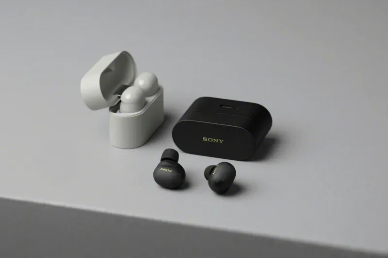 Sony WF-1000XM6 wireless earbuds: open white case with earbuds, closed black case with 'Sony' logo, and loose black earbuds on table.