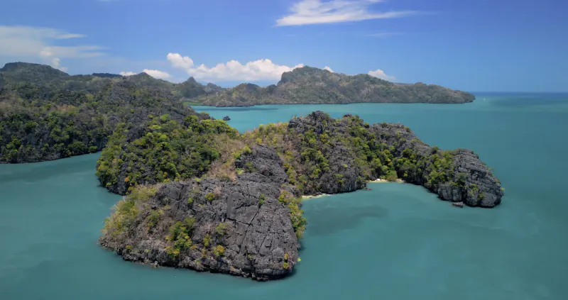 Aerial view of lush green rocky islands and turquoise waters at Ambong-Ambong, Langkawi, Malaysia