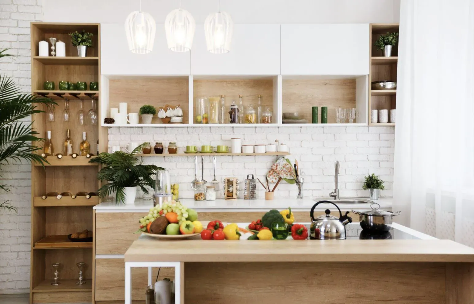Modern luxury kitchen with wooden cabinets, white subway tiles, pendant lights, fresh fruits and vegetables on counter