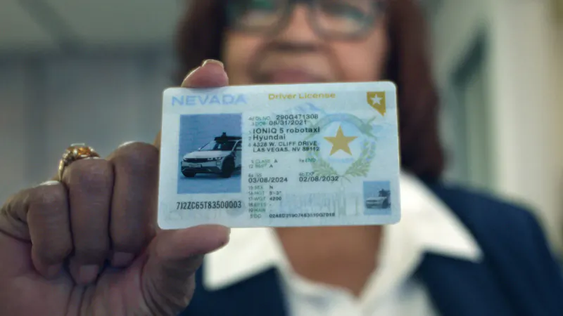 Woman holding Nevada driver's license with Hyundai IONIQ 5 photo and gold star