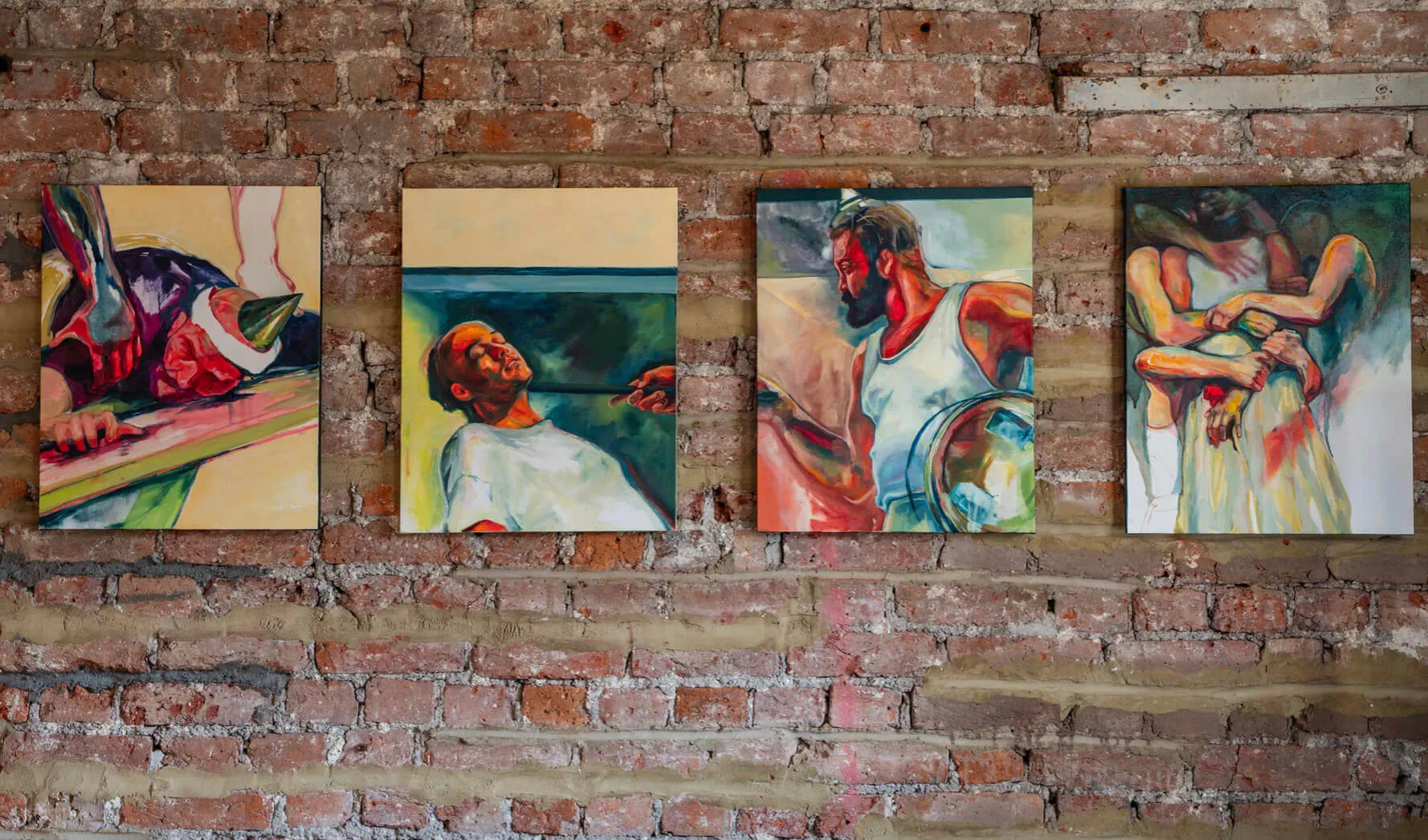 Four abstract paintings of expressive figures on a brick wall in Body & Theatre exhibition by Marina Renee-Cemmick
