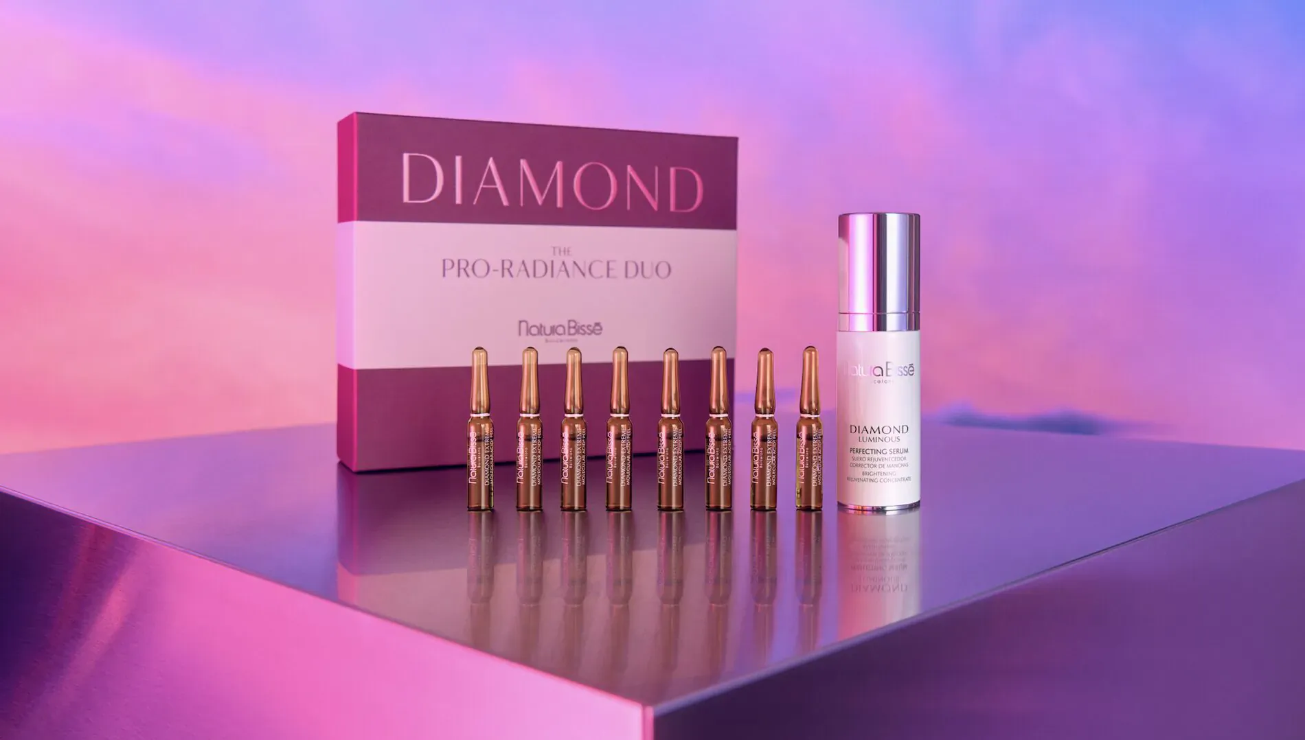 Diamond Extreme Molecular Proageing skincare set: open box with 8 ampoules and dropper serum on purple pedestal.